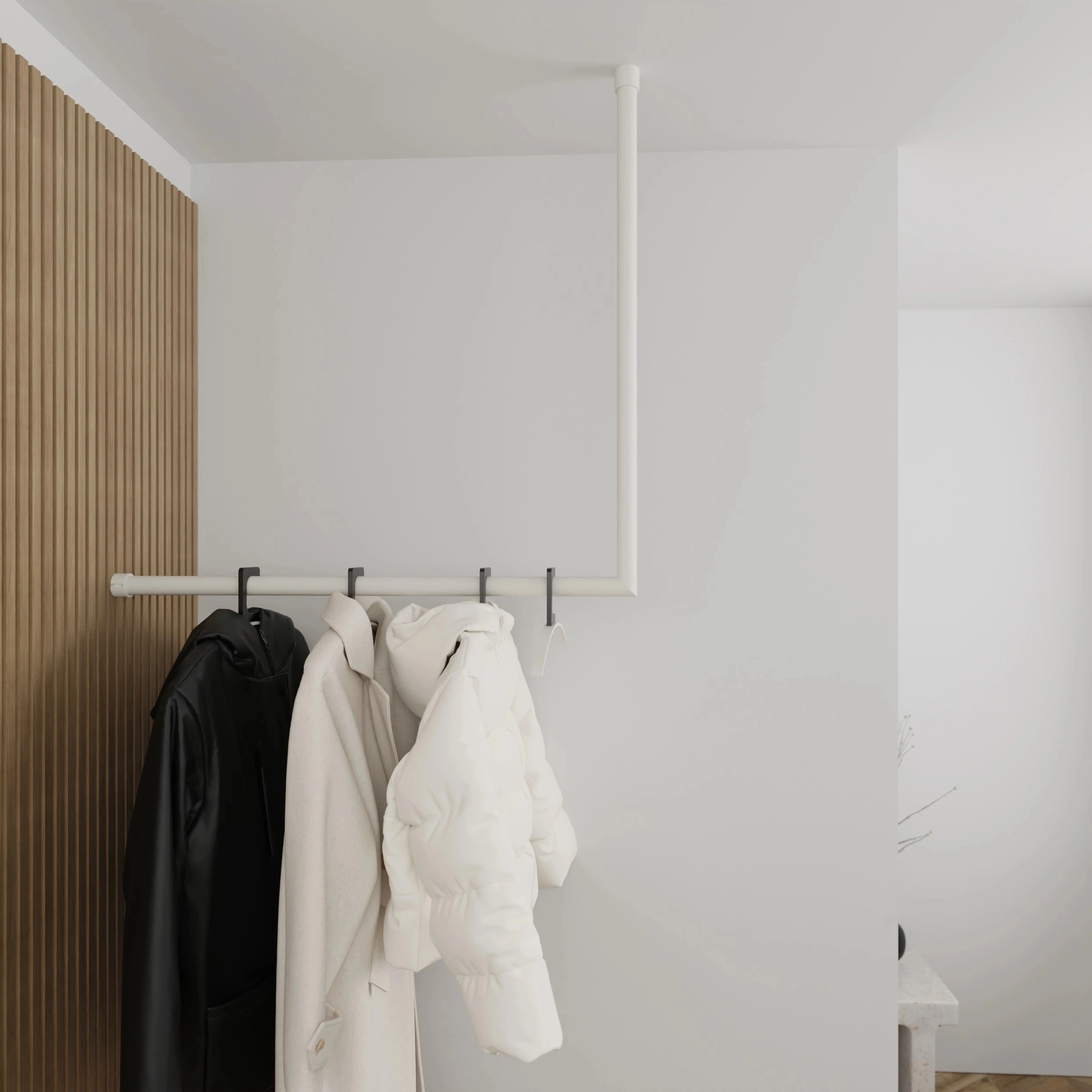 Garderobe Lovan rund weiß in einem Interieur mit Kleidung an der Wand montiert.