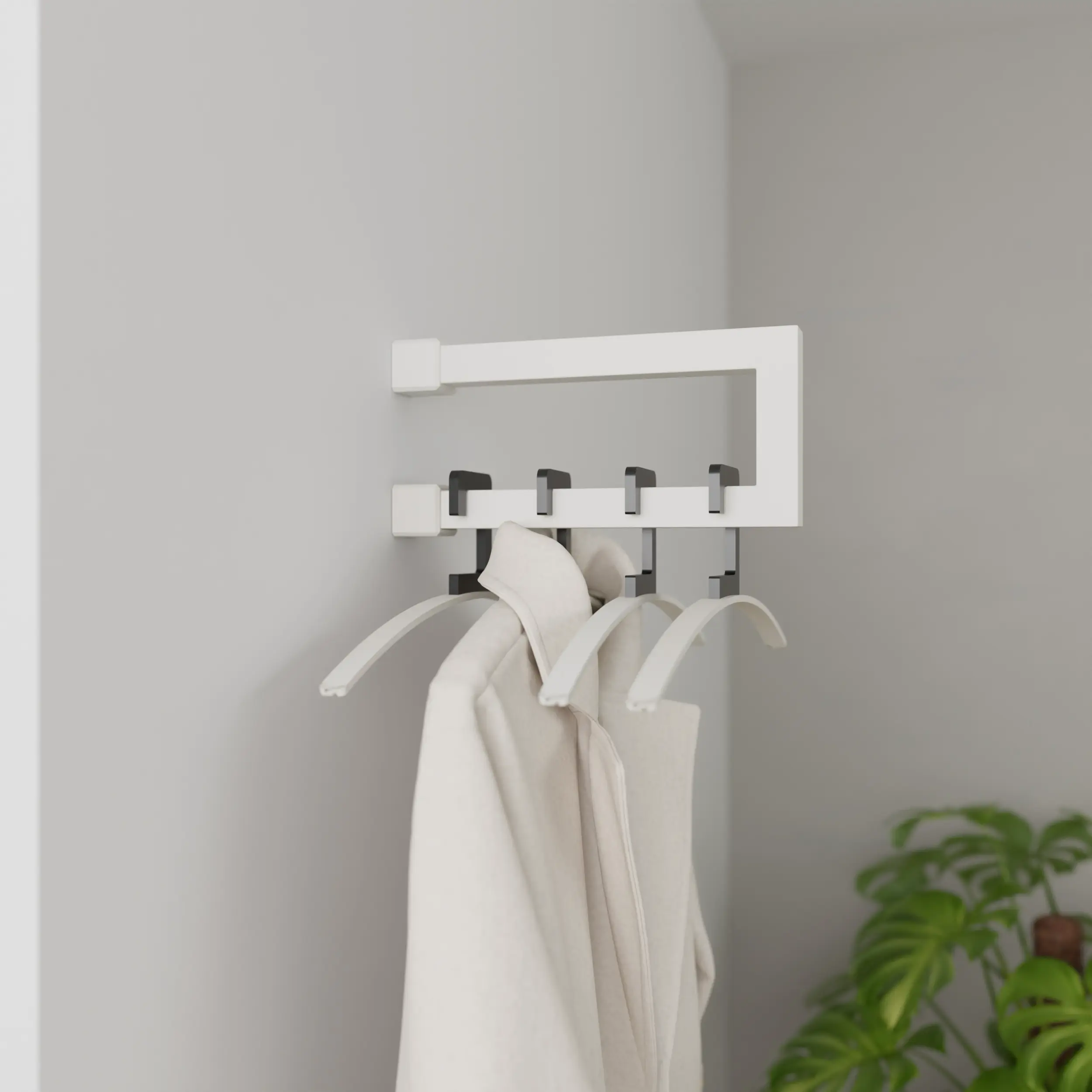 Wandgarderobe Eslin quadratisch weiß in einem Interieur mit Kleidung an der Wand montiert.