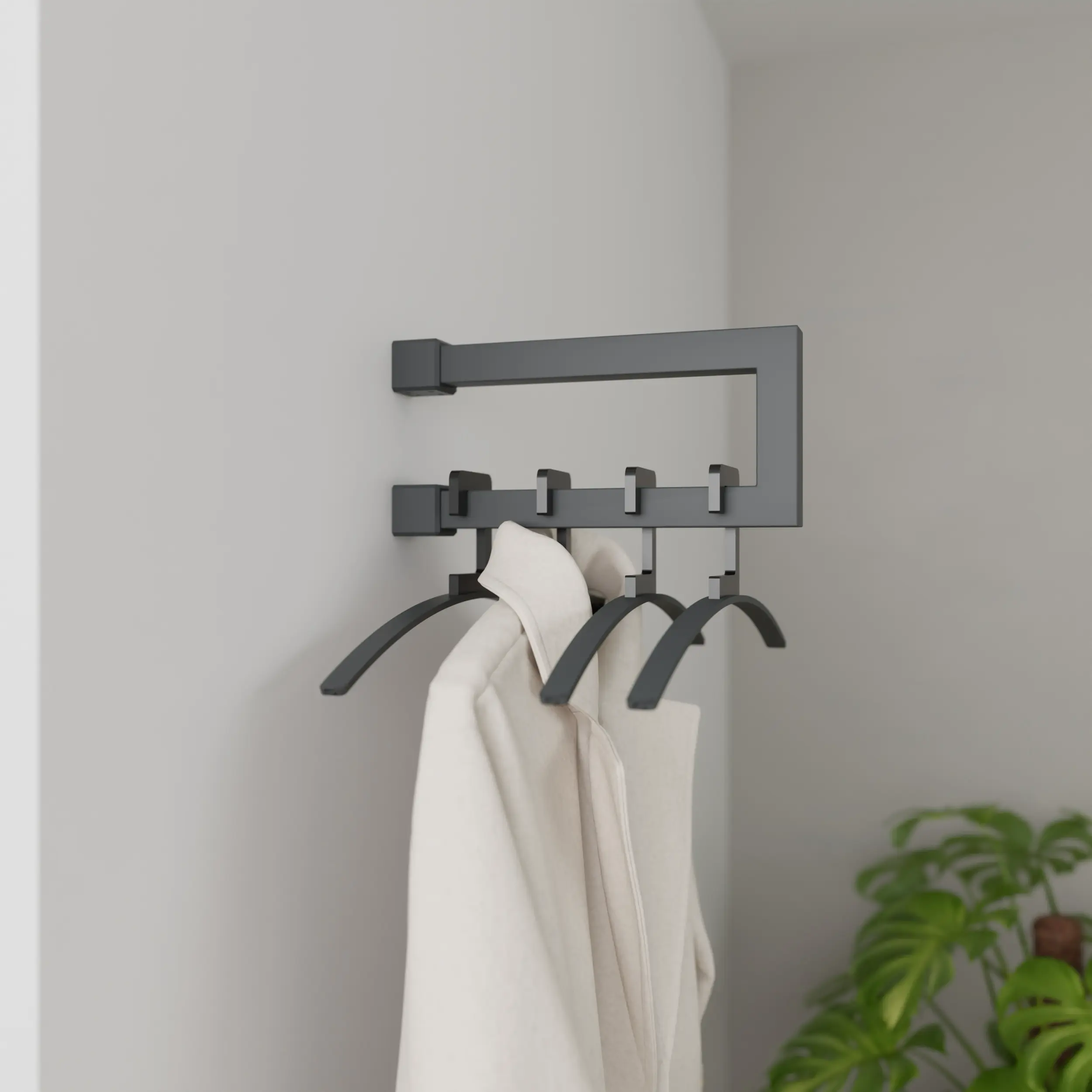 Wandgarderobe Eslin quadratisch anthrazit in einem Interieur mit Kleidung an der Wand montiert.