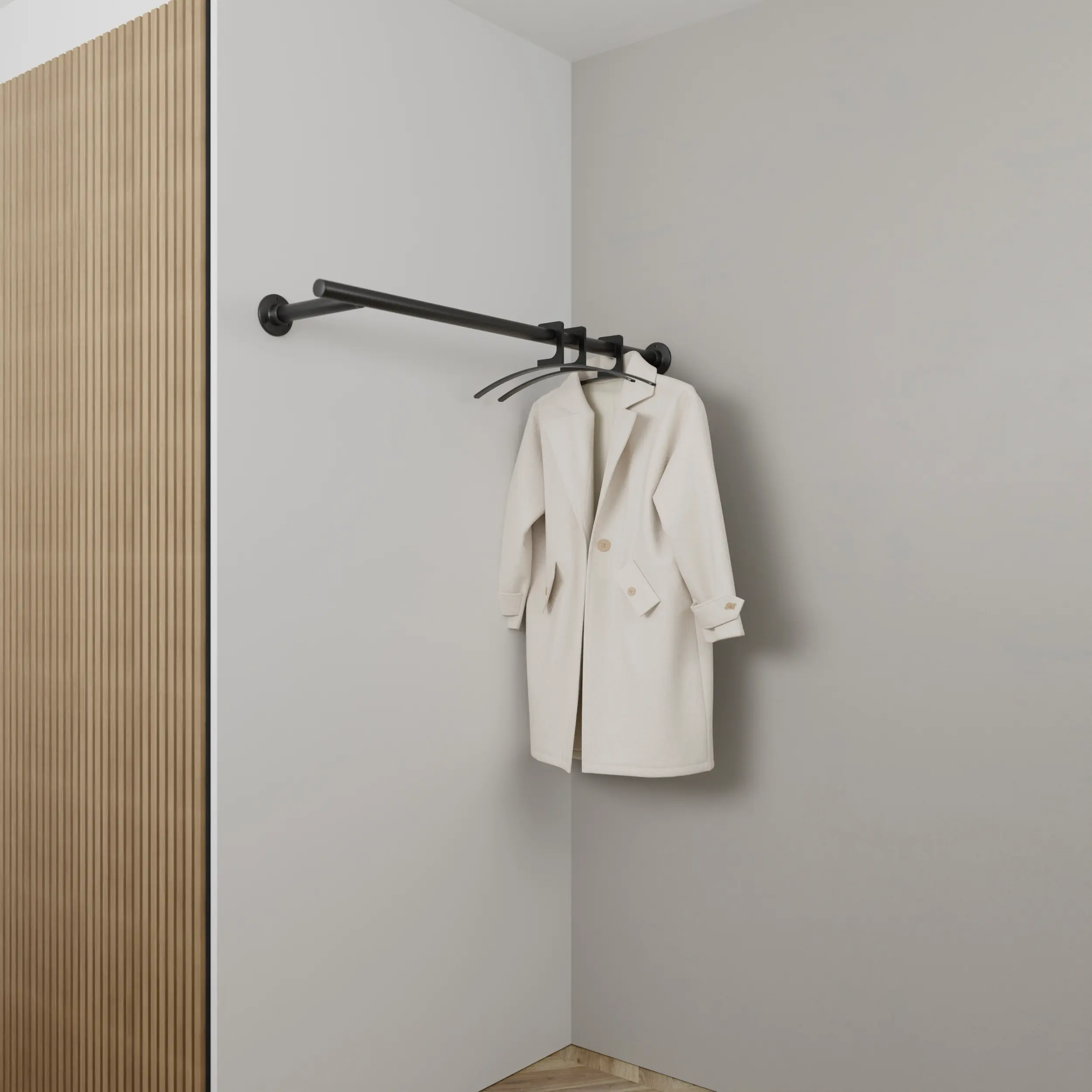 Wandkapstok Zolma rond zwart aan de wand gemonteerd in een interieur met kleding.