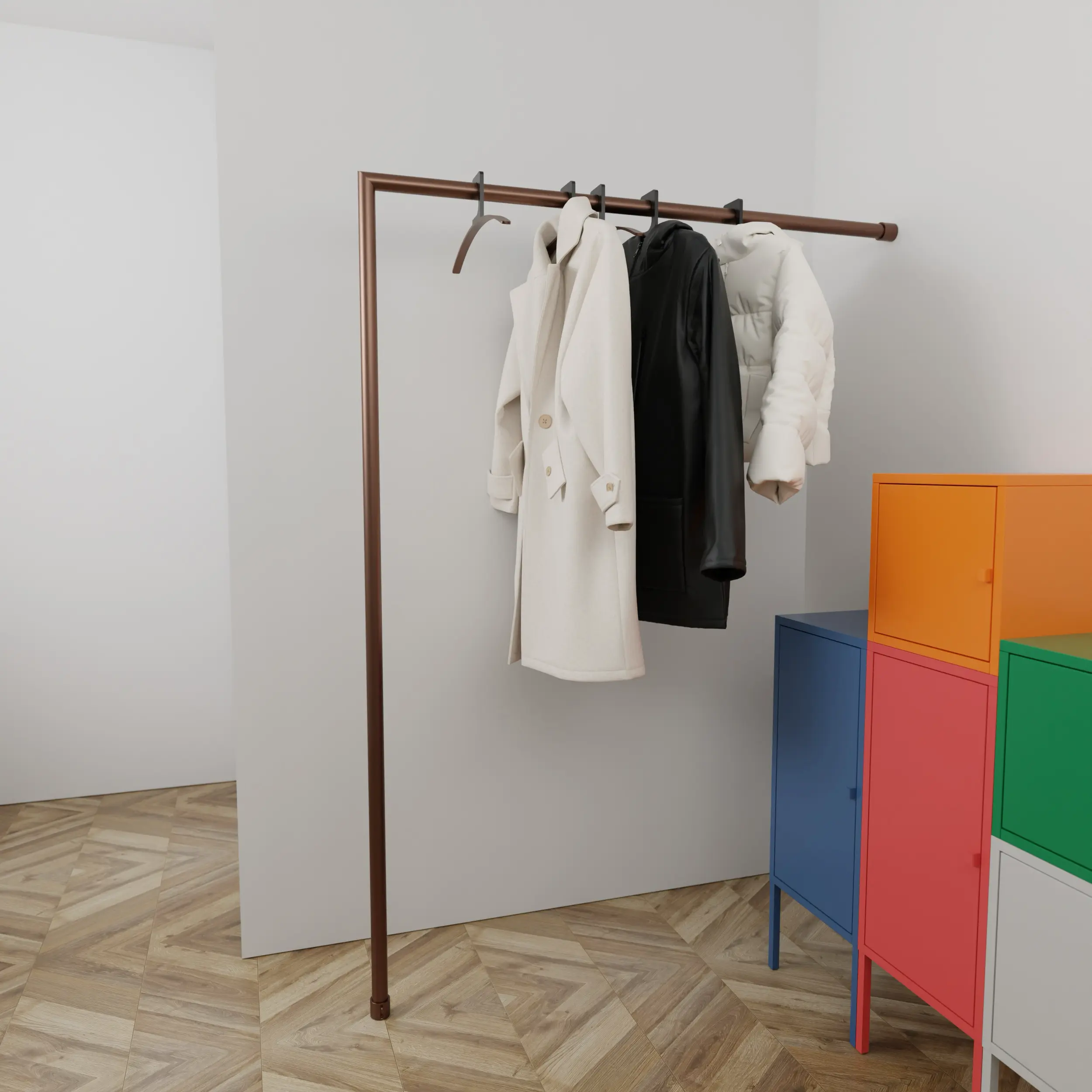 Coat rack Lavenne round bronze in a bright interior with clothing on the coat rack and a green plant.