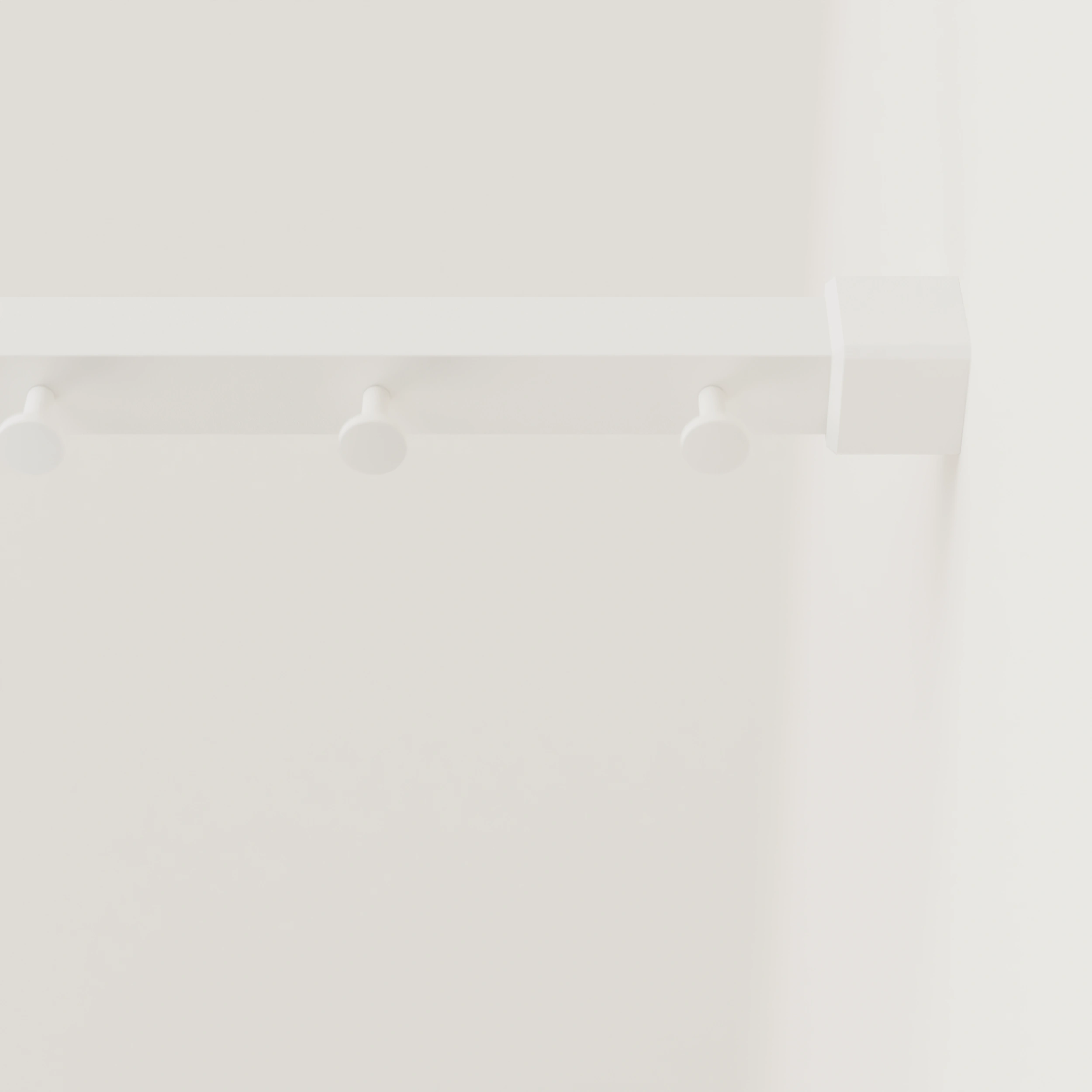 Clothes rail B square white mounted on the wall in an interior with clothing.