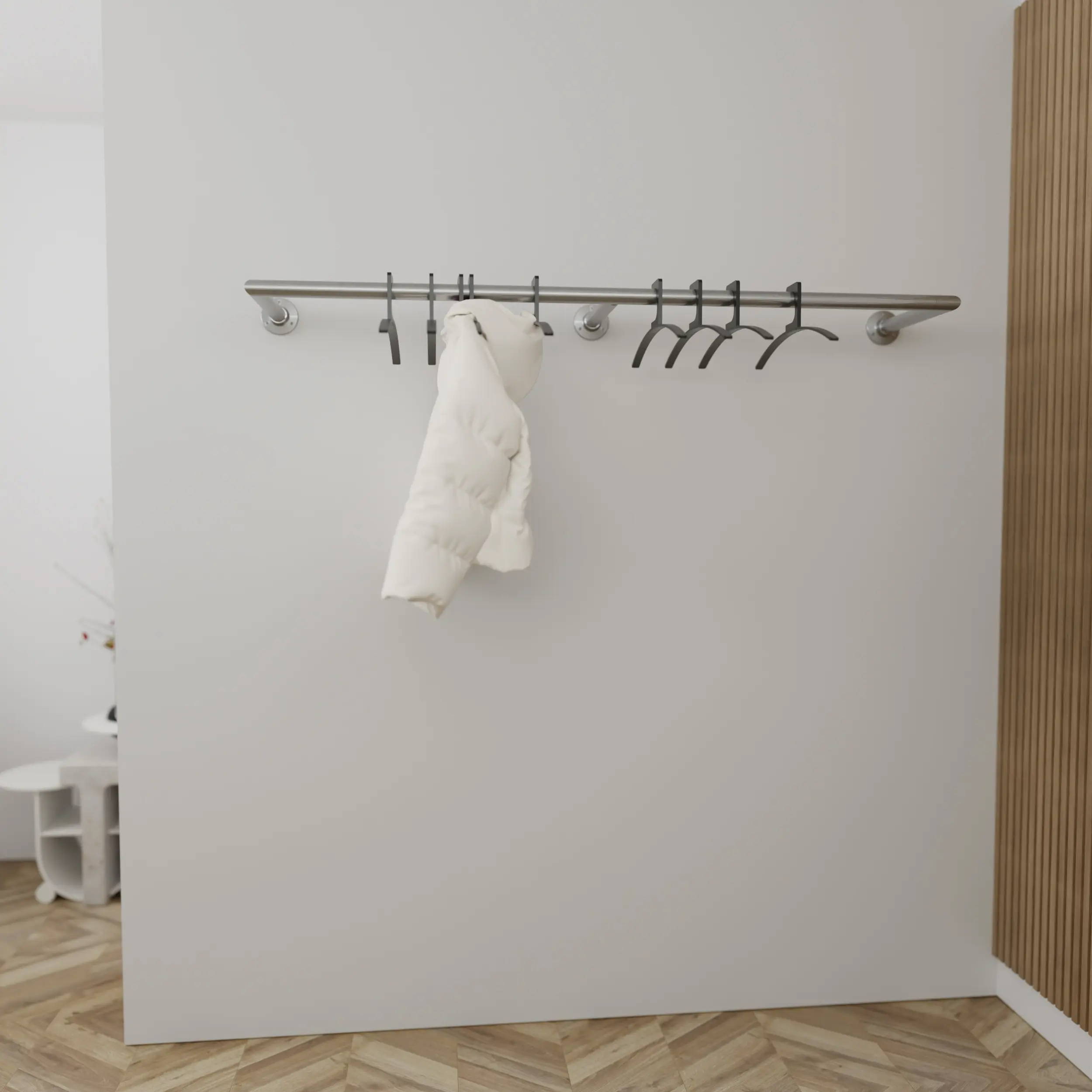 Wall-mounted coat rack Merlin round stainless steel mounted on the wall in an interior with clothing.