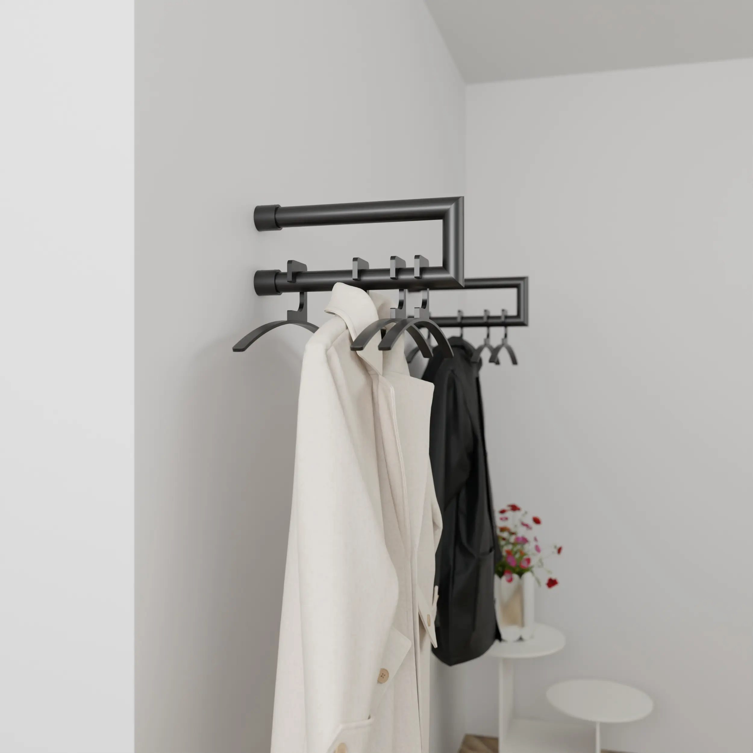 Wandgarderobe Eslin rund schwarz in einem Interieur mit Kleidung an der Wand montiert.