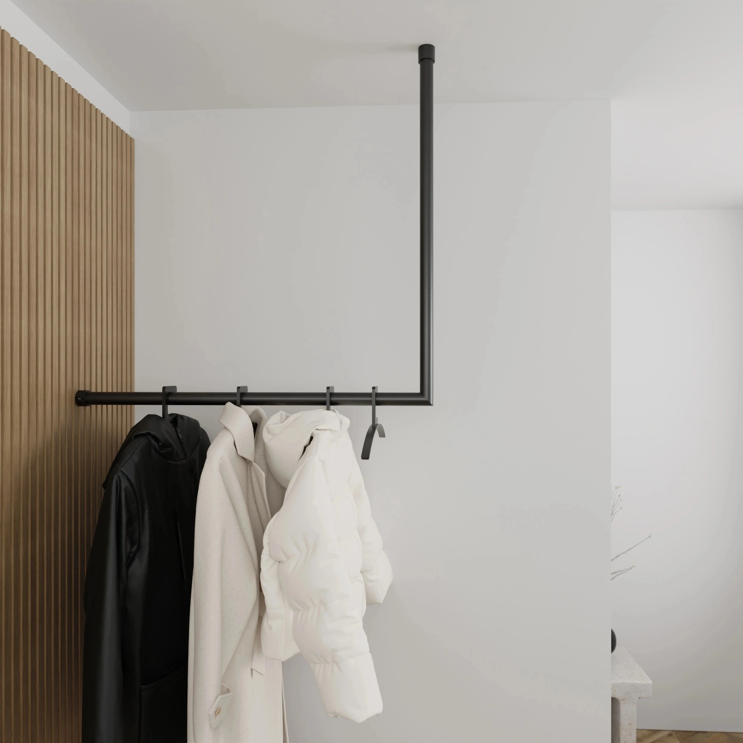 Coat rack Lovan round black mounted on the wall in an interior with clothing.