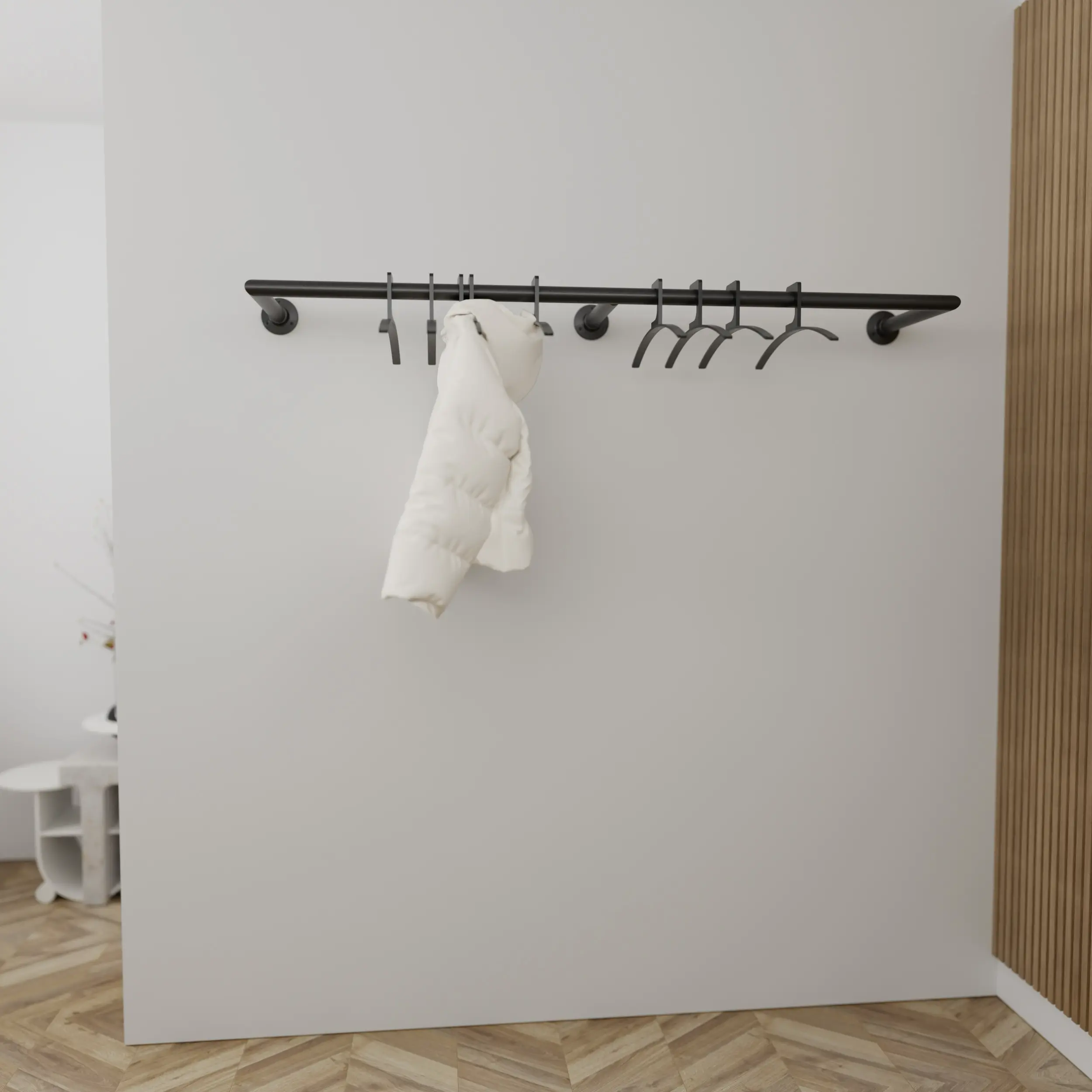 Wandgarderobe Merlin rund schwarz in einem Interieur mit Kleidung an der Wand montiert.