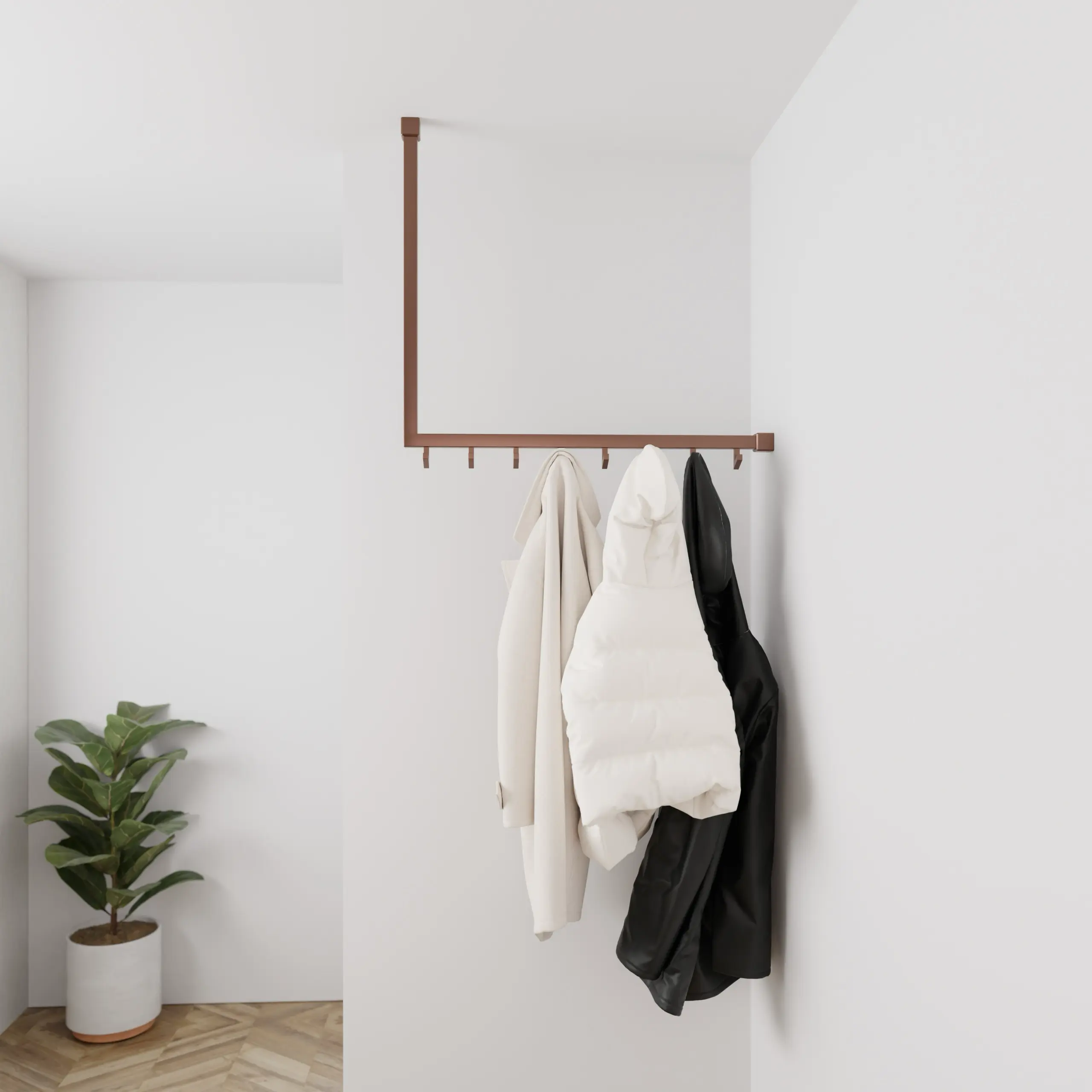 Garderobe Lovan quadratisch bronze in einem Interieur mit Kleidung an der Wand montiert.