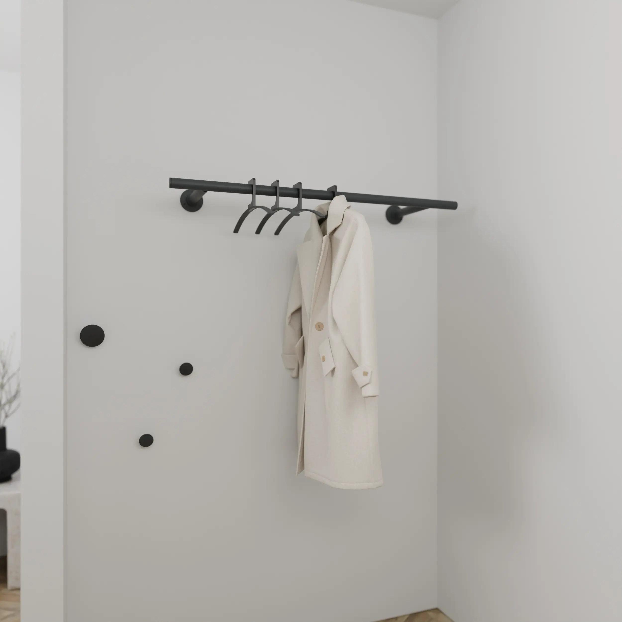 Garderobe Zelhof rund anthrazit in einem Interieur mit Kleidung an der Wand montiert.