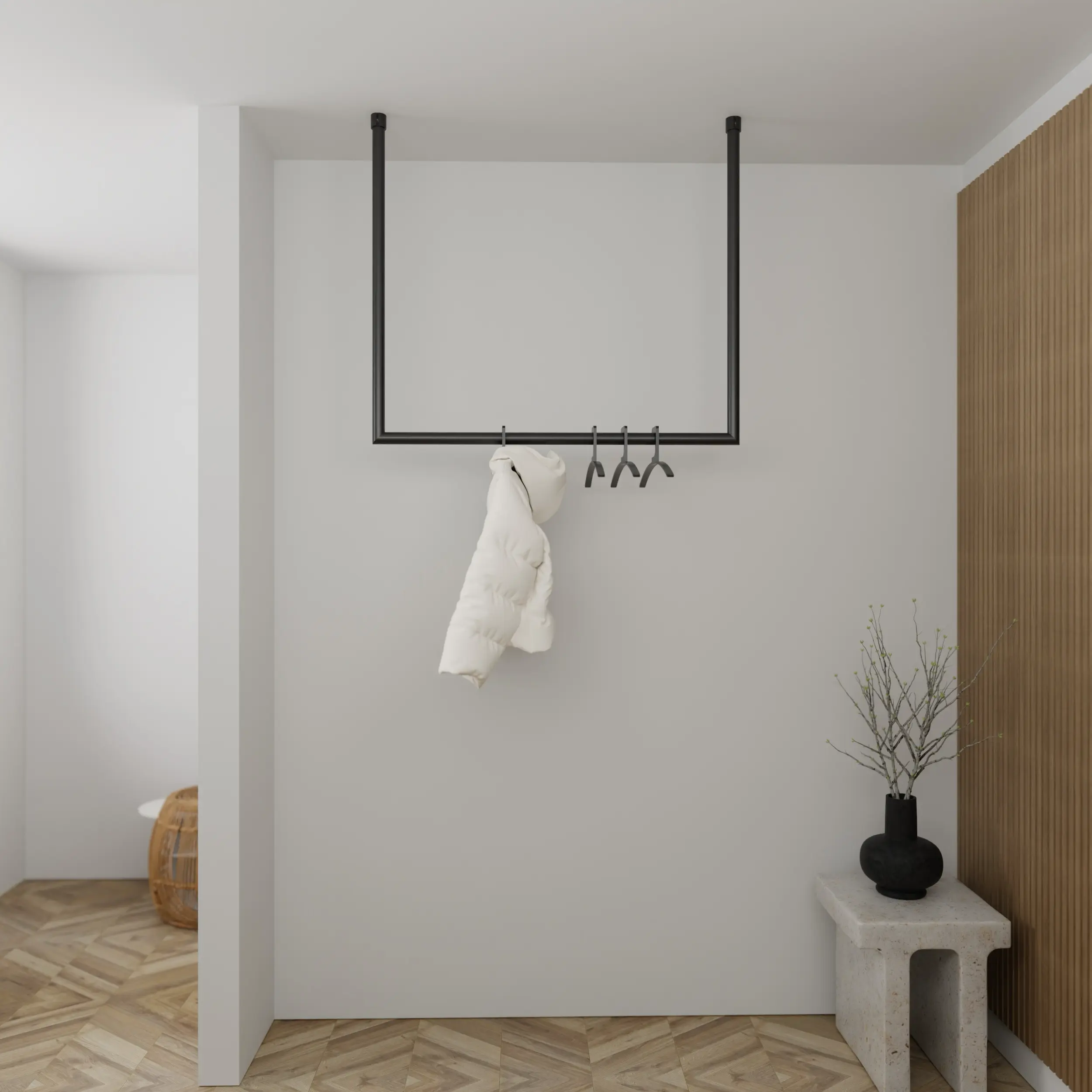 Kapstok Nalen rond zwart aan de wand gemonteerd in een interieur met kleding.