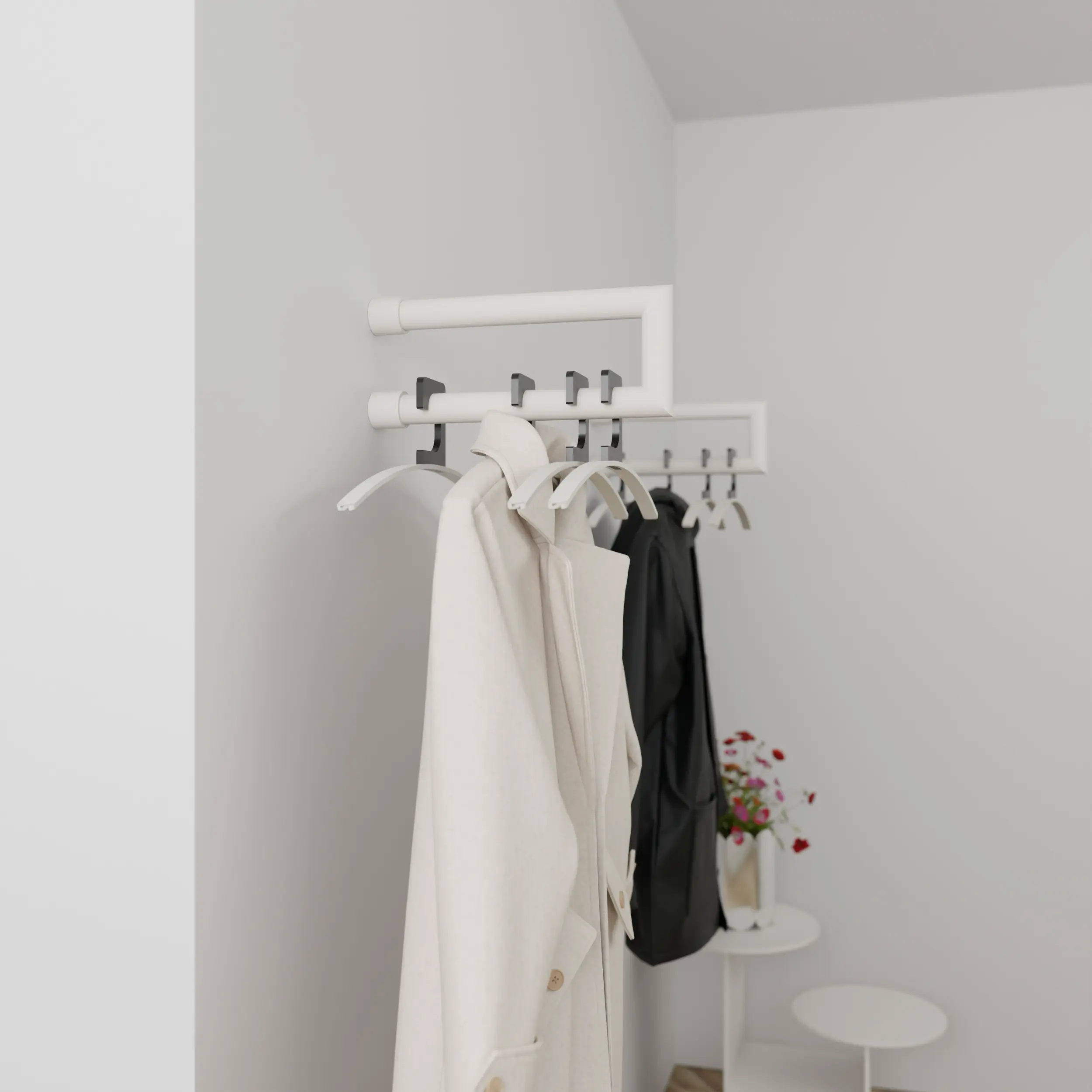 Wandkapstok Eslin rond wit aan de wand gemonteerd in een interieur met kleding.
