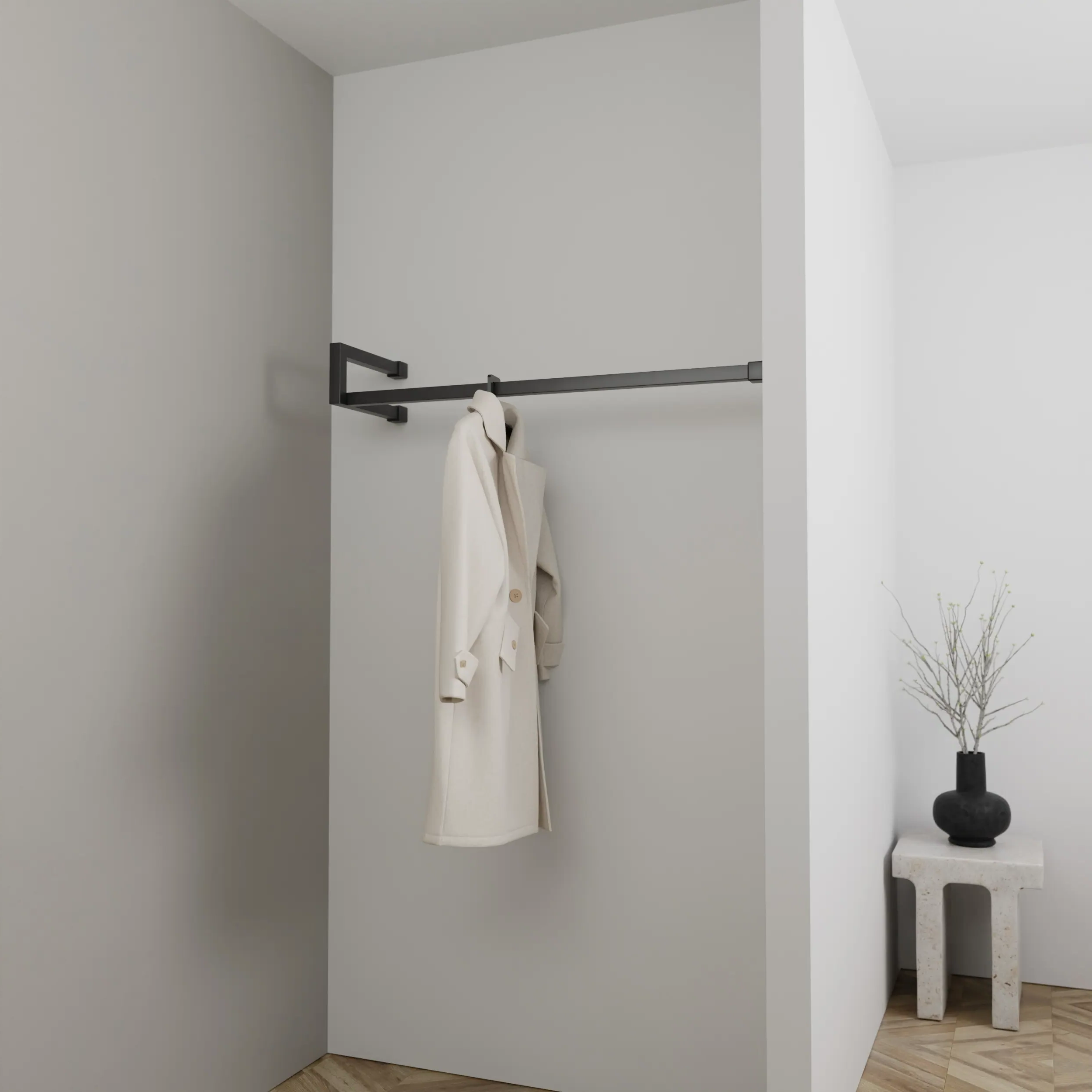 Kapstok Lorien vierkant zwart aan de wand gemonteerd in een interieur met kleding.