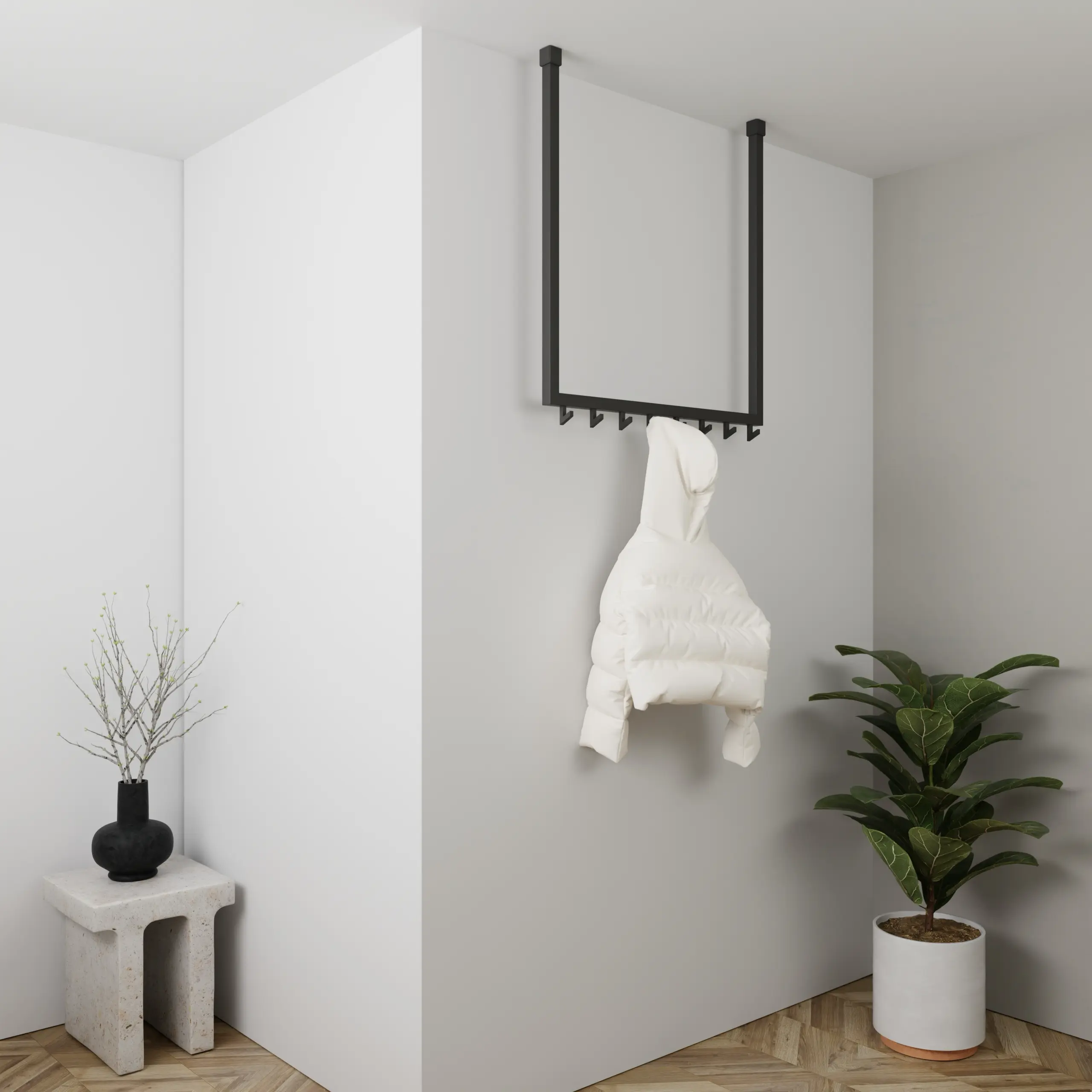 Garderobe Nalen quadratisch schwarz in einem Interieur mit Kleidung an der Wand montiert.