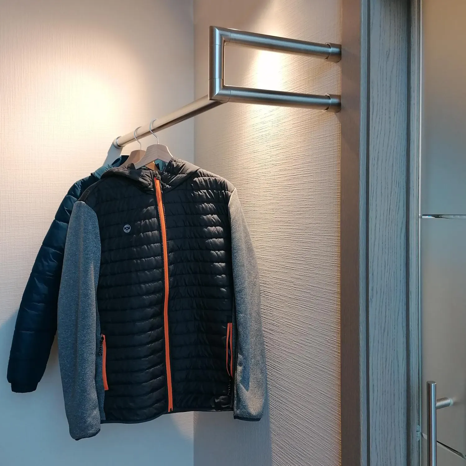 Wall-mounted coat rack Lorien round stainless steel left corner shown as a cut-out product view.