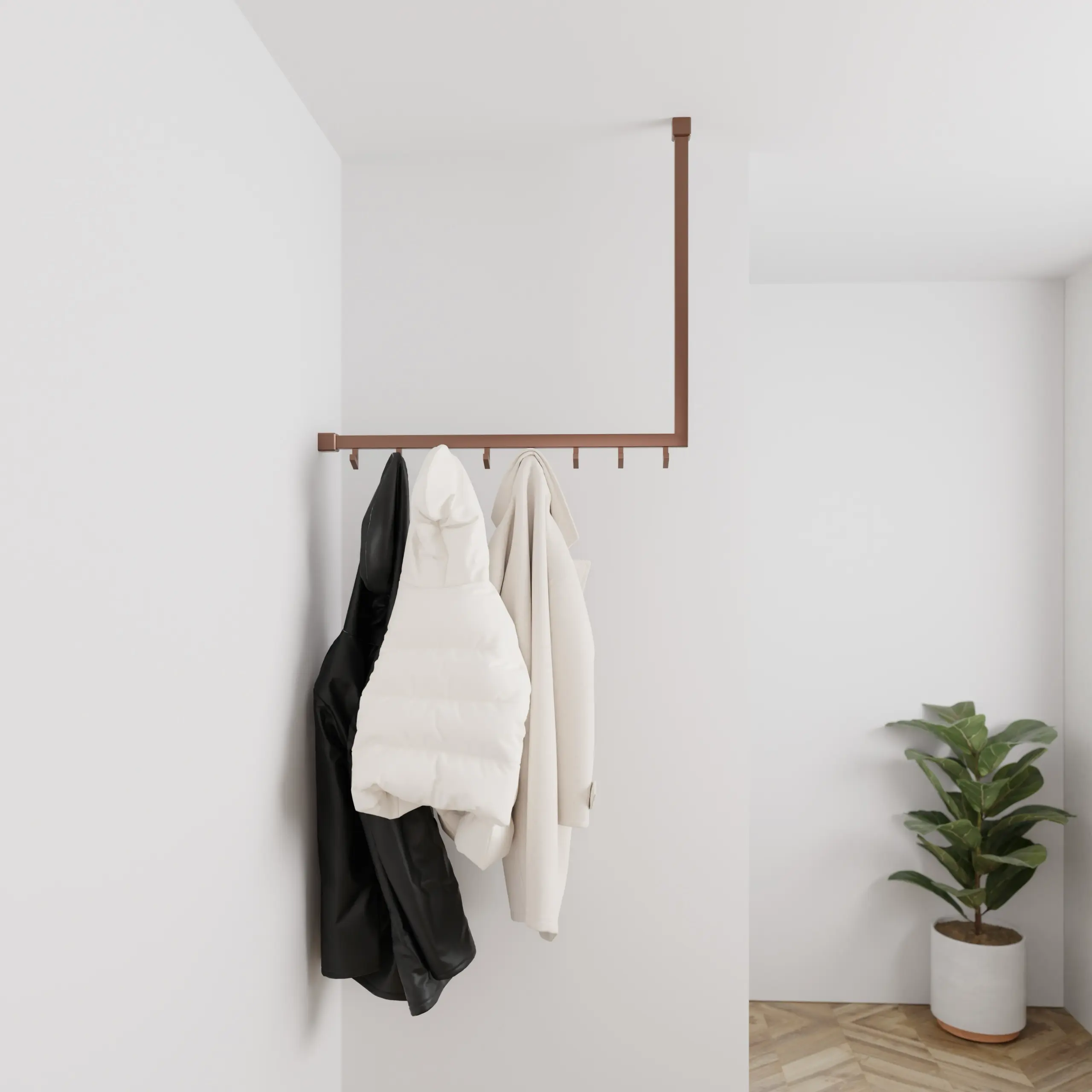 Kapstok Lovan vierkant brons aan de wand gemonteerd in een interieur met kleding.