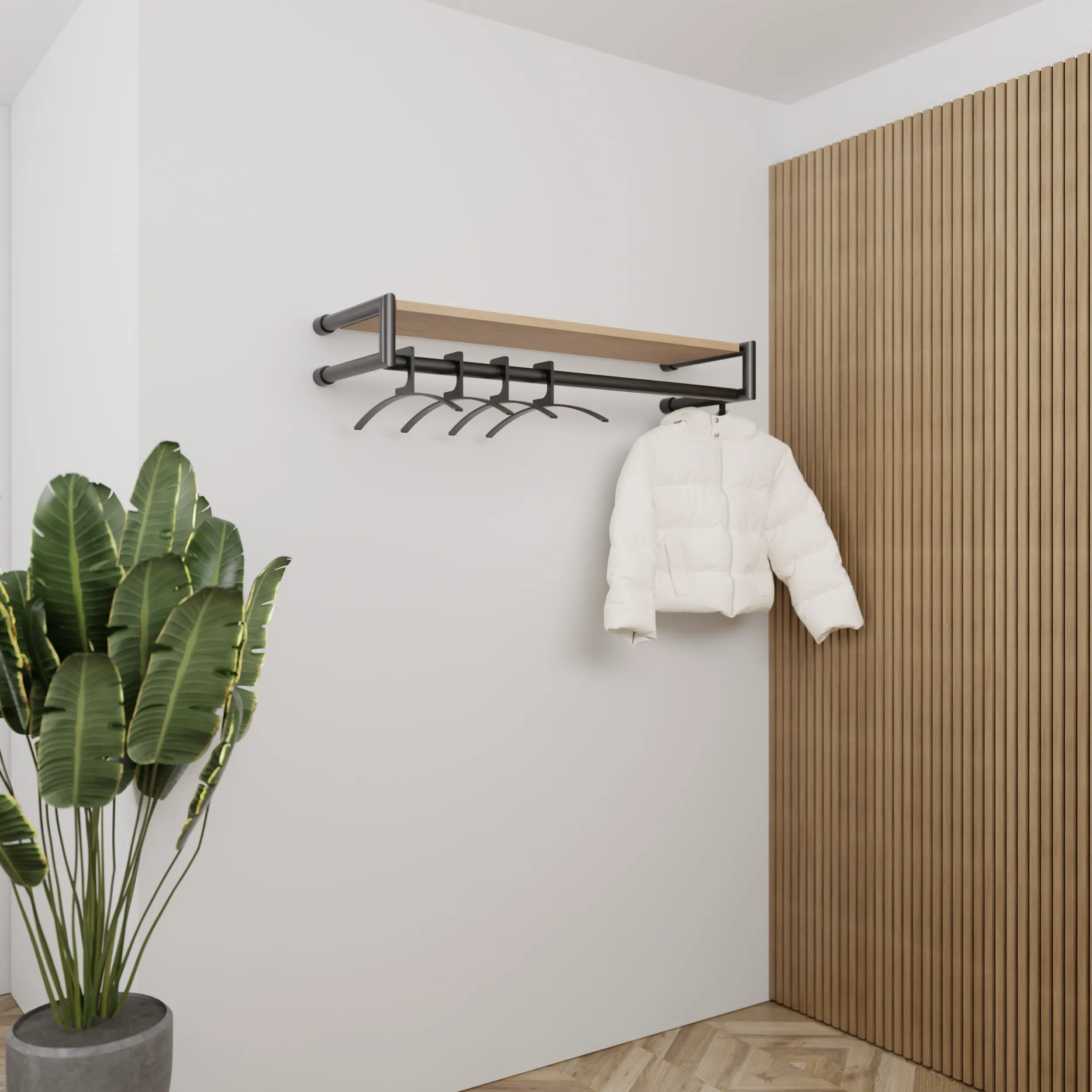 Garderobe Ulena rund schwarz in einem Interieur mit Kleidung an der Wand montiert.