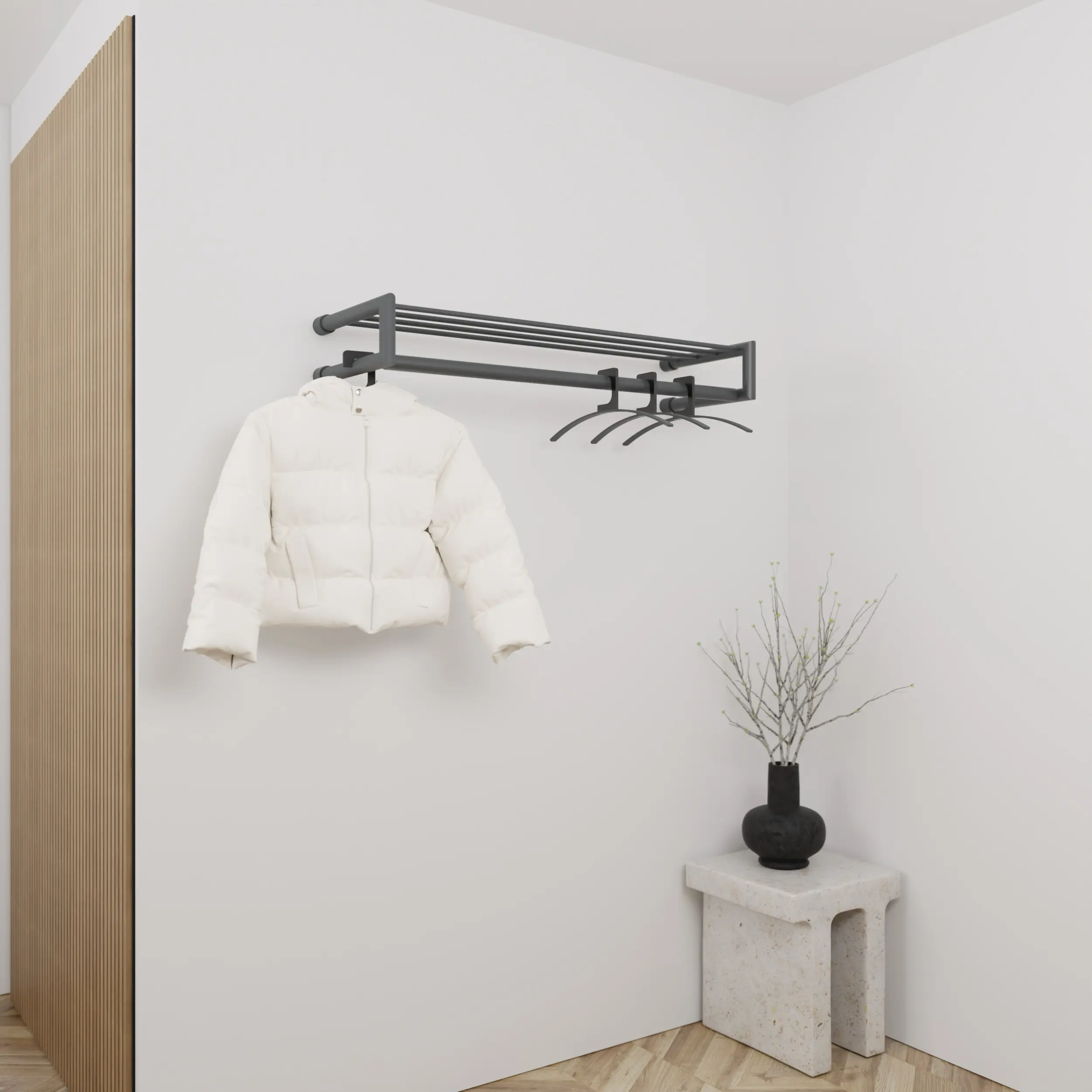 Garderobe Uven rund anthrazit in einem Interieur mit Kleidung an der Wand montiert.