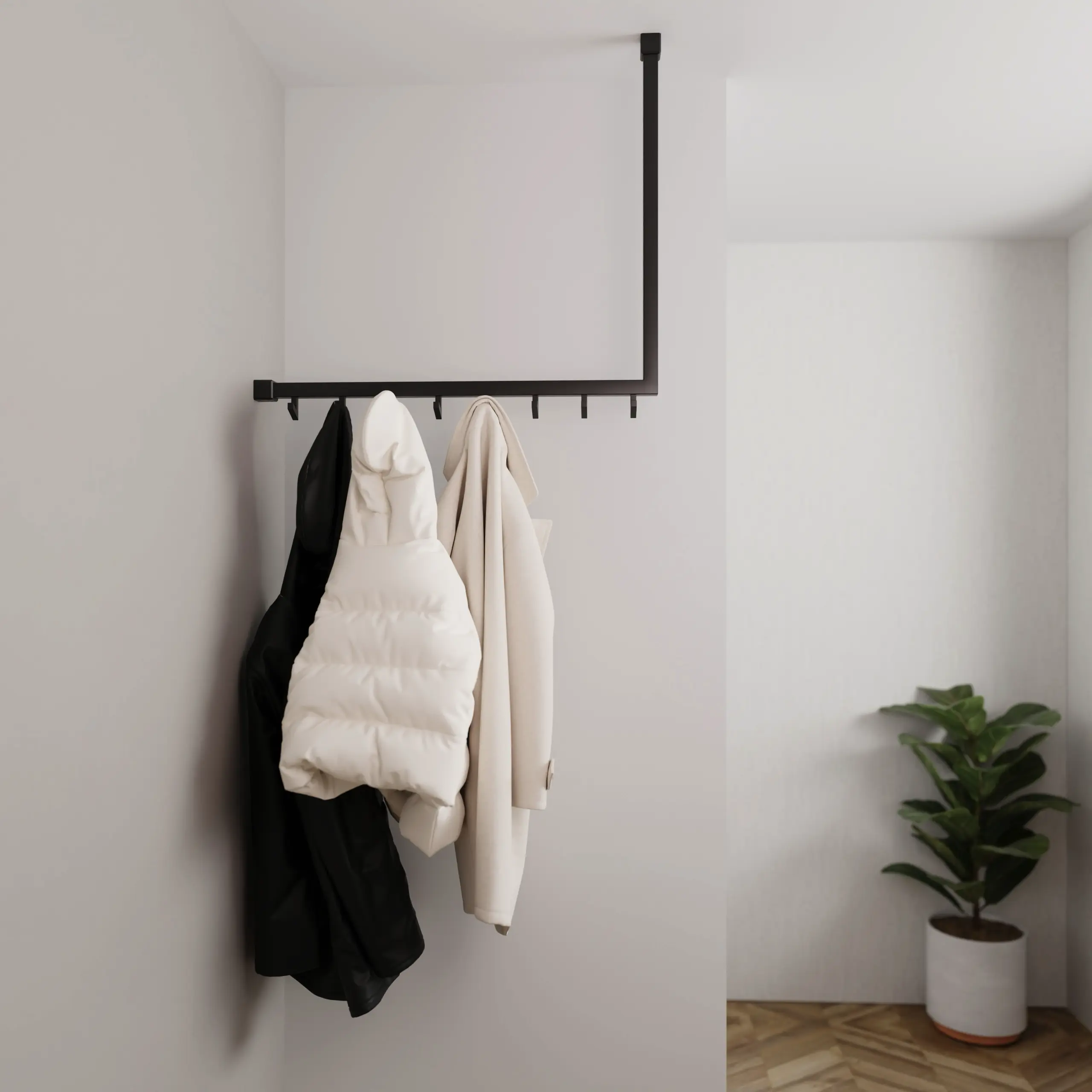 Garderobe Lovan quadratisch schwarz in einem Interieur mit Kleidung an der Wand montiert.