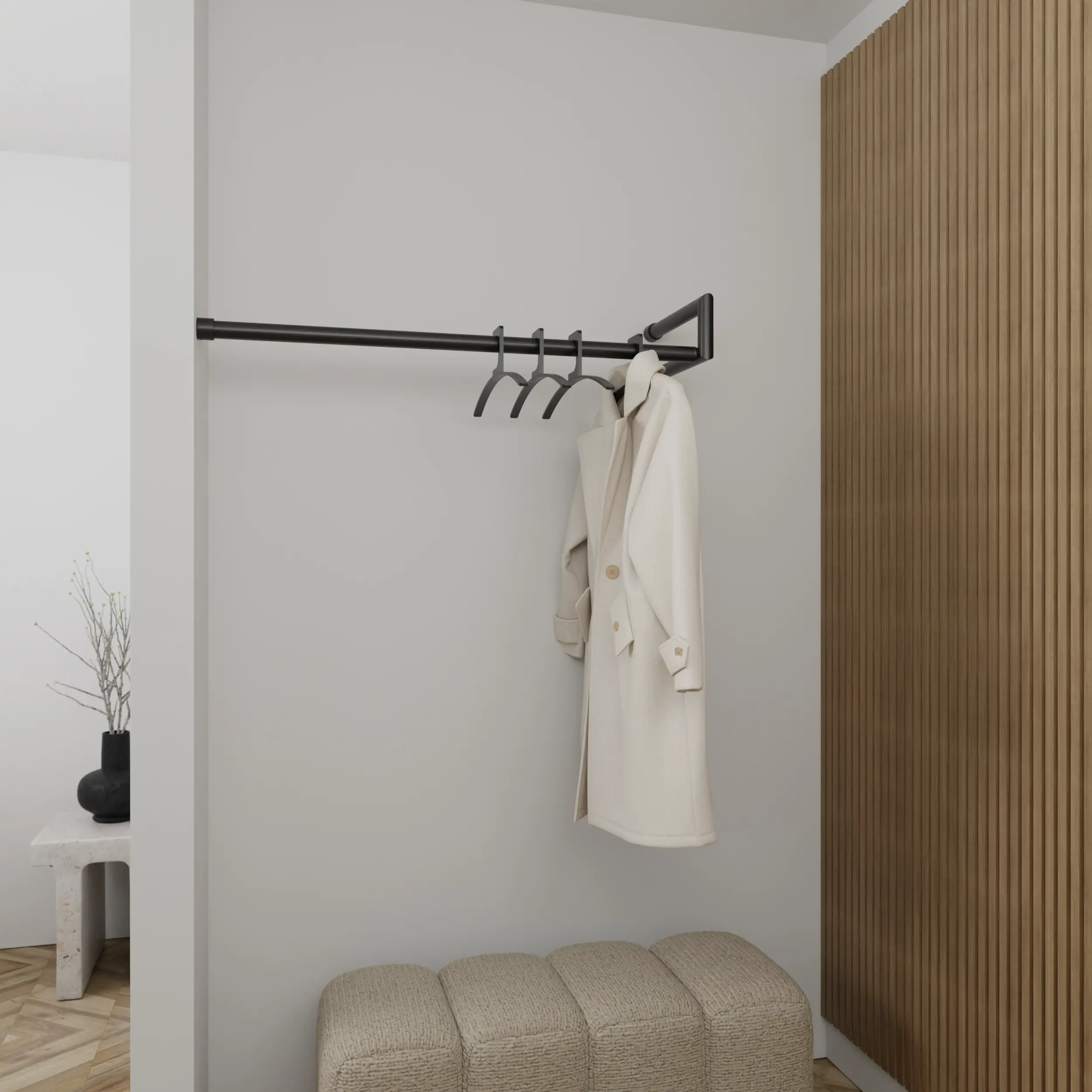 Garderobe Lorien rund schwarz in einem Interieur mit Kleidung an der Wand montiert.