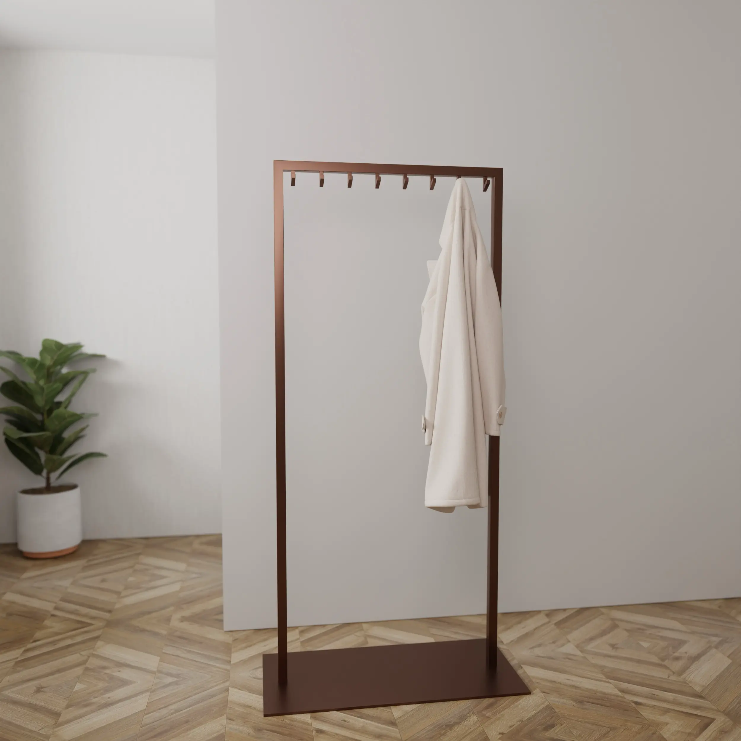 Kapstok Taren brons aan de wand gemonteerd in een interieur met kleding.
