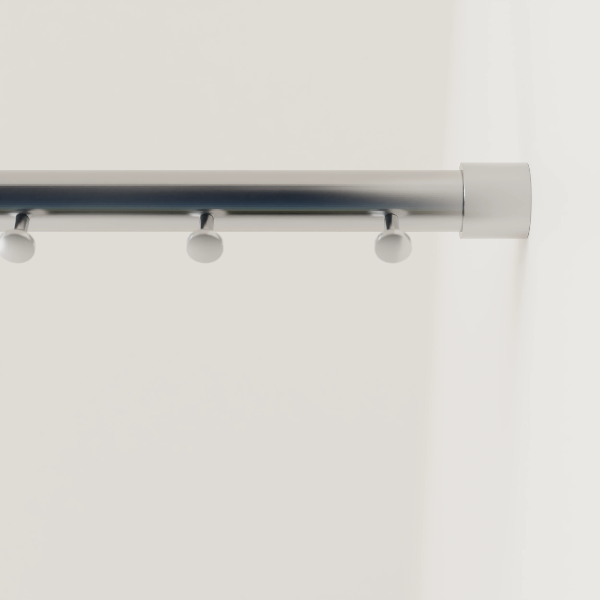 Garderobestang B rond RVS aan de wand gemonteerd in een interieur met kleding.