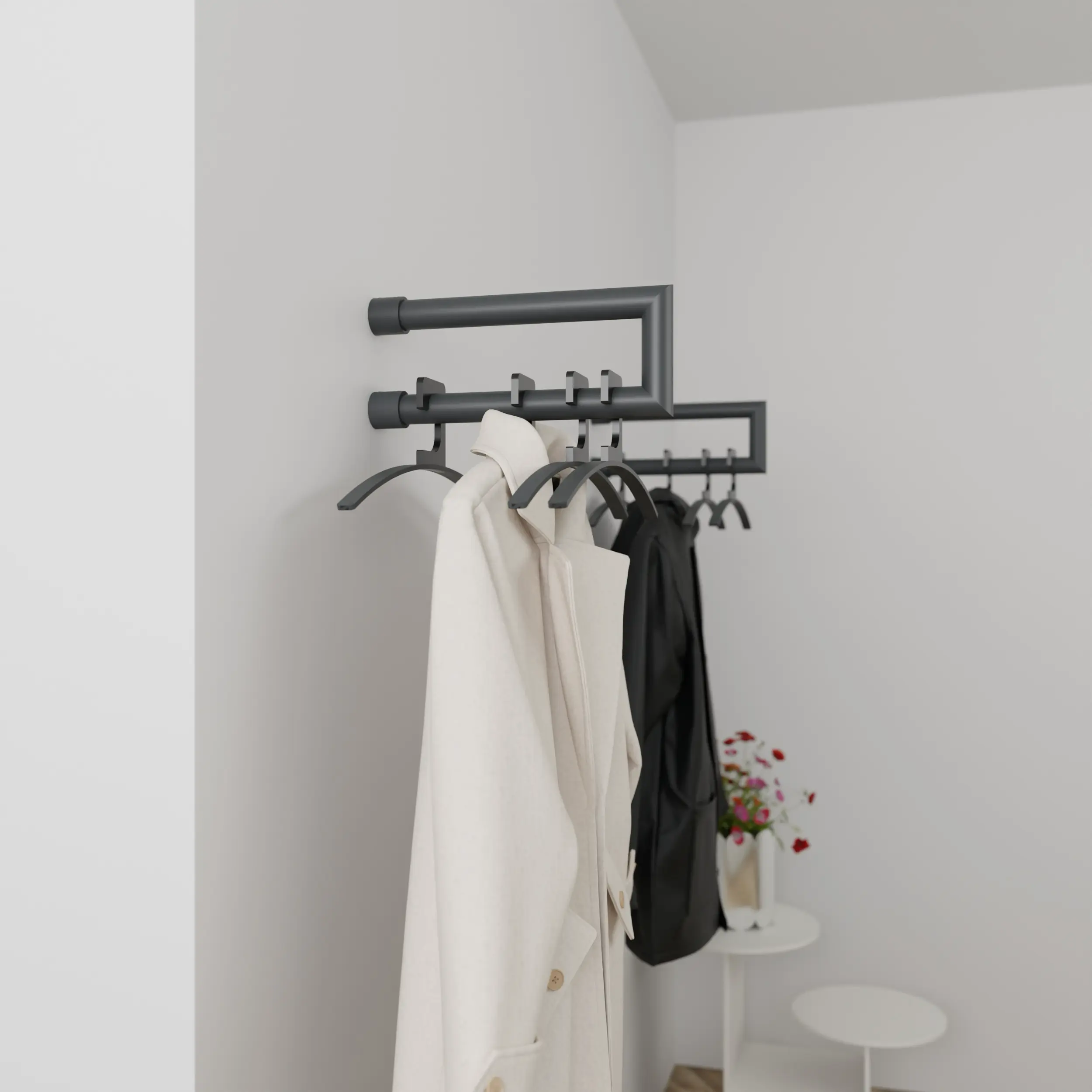 Wandkapstok Eslin rond antraciet aan de wand gemonteerd in een interieur met kleding.
