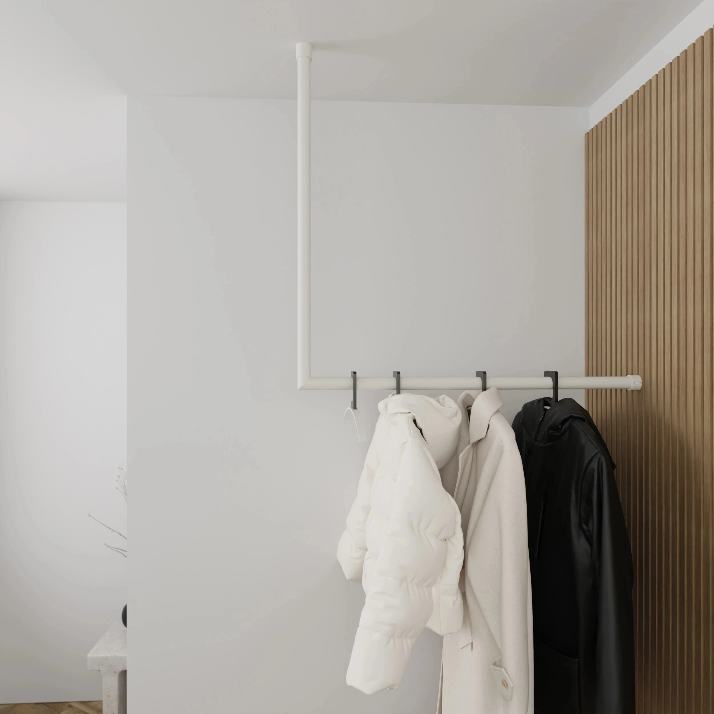 Coat rack Lovan round white mounted on the wall in an interior with clothing.