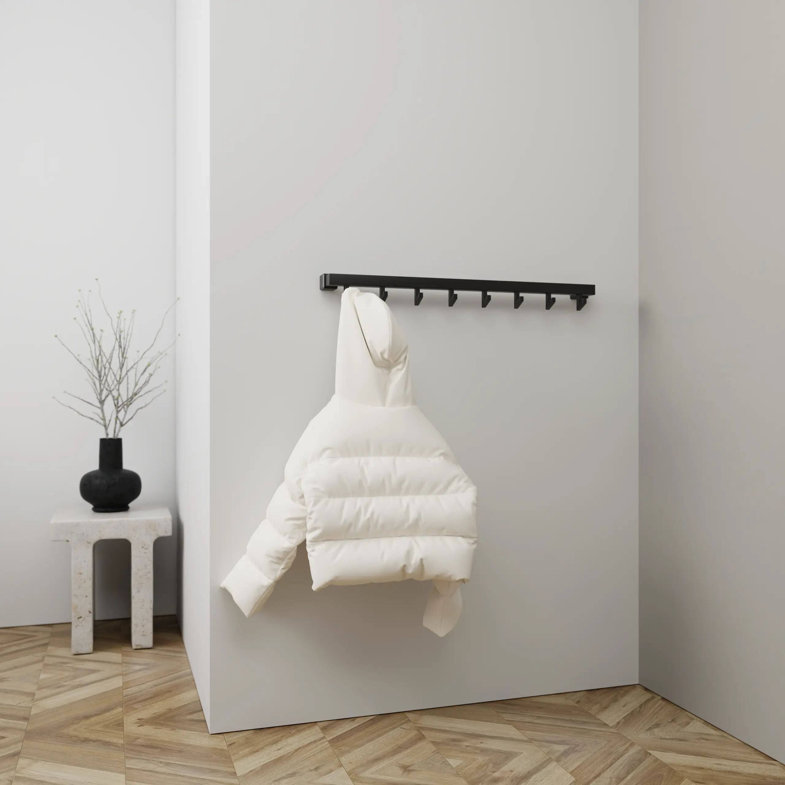 Wandgarderobe Hylan quadratisch schwarz in einem Interieur mit Kleidung an der Wand montiert.